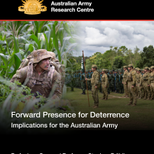 Cover image of publication, including a hybrid image combining two photographs.  One image showing an Australian Army soldier on patrol during an Army exercise is merged with a second image showing military members of two different nationalities on parade.