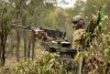 Australian Army soldier from the 2nd Cavalry Regiment stands in his Australian Light Armoured Vehicle before commencing a live-fire serial in the Townsville Field Training Area during Exercise Eagle March.