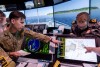 Australian Army officer Lieutenant Sabre Medhurst and Royal Australian Navy instructor Lieutenant Hayden Eadir viewing the Radar and Navigation Display System while undertaking the RAN Maritime Warfare Officers Course (MWOC) at Navy Training System Centre – West, HMAS Stirling.