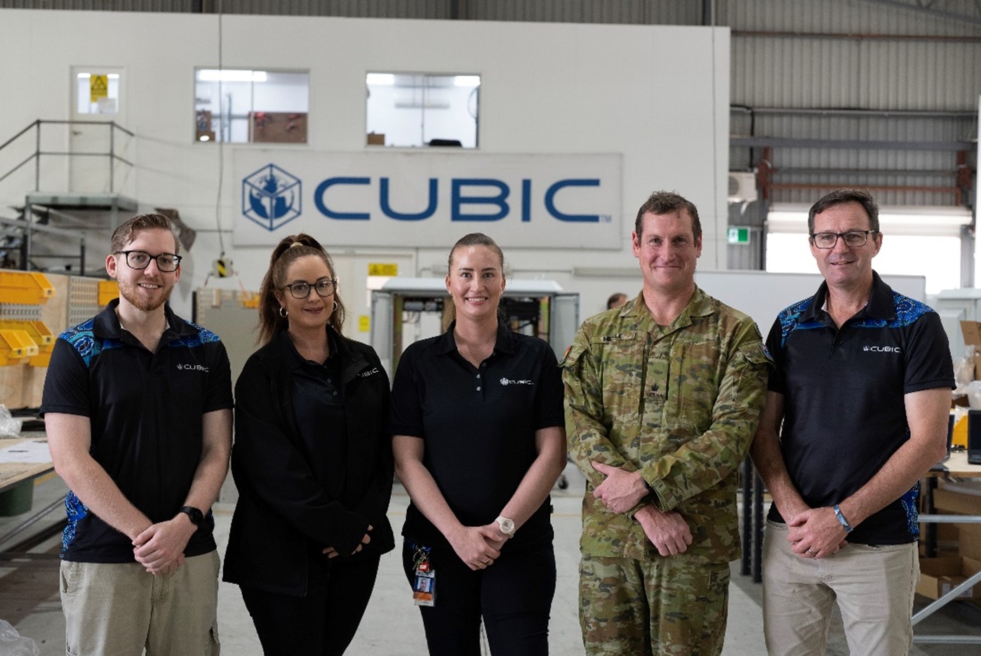 The CUBIC Defence team and Major Josh Mickle at their workshop in Townsville. 